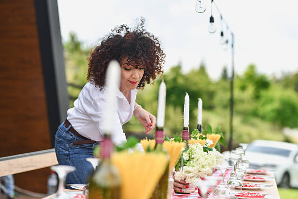 istock Graceful Woman Putting Final Touches on Stylish and Refined Table Setting 2219337225