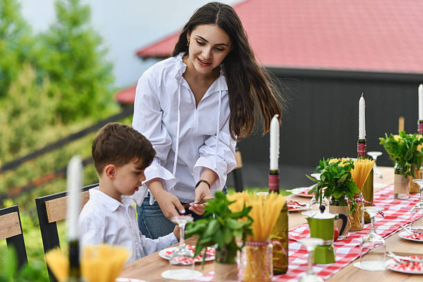 istock Big Sister Teaching Younger Brother How to Properly Place Utensils on Table 2219337261