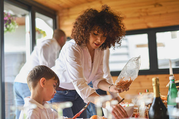 istock Beautiful Woman Helping Son While He's Deciding What to Eat From Buffet 2219337411