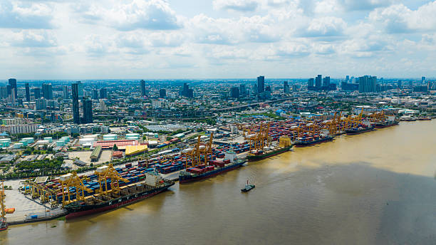 istock Bangkok,Thailand - May 3, 2024 : Logistics and transportation of container cargo ship at ship port. Container truck and crane bridge in shipyard. Import export and transport industry. Terminal port for export transport by ship. 2219337564