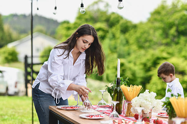 istock Excited Woman Neatly Finishing Decorating the Celebration Table 2219337585