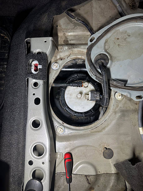 istock Exposed car fuel pump assembly with wiring and connectors during diagnostics or replacement, top view 2219338164