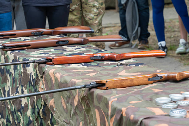 istock Air rifles on a camouflage table at a shooting event 2219338172