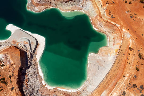 View from above. Hole of an old gold mine with water.