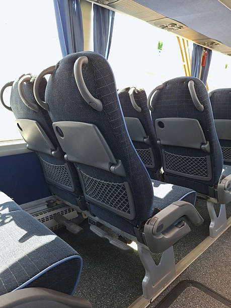 istock Empty bus interior with modern blue reclining seats and tray tables 2219339794