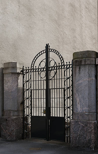 istock a striking black wrought iron gate with a symmetrical, geometric design dominated by circular patterns and an arched top 2219340471