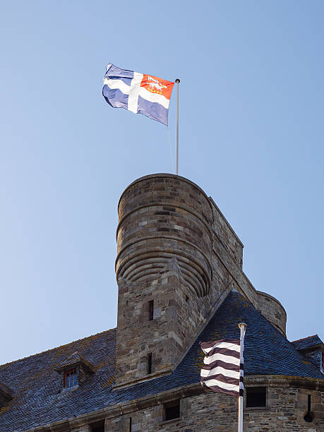 istock Saint-Malo city hall tower with regional flags under clear blue sky 2219342621