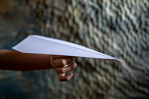girl flying a paper plane