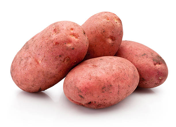 istock Four new red potatoes stained with soil isolated on white background 2219344925