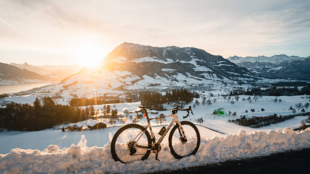 istock Bicycle parked on snowy road above mountains 2219345034