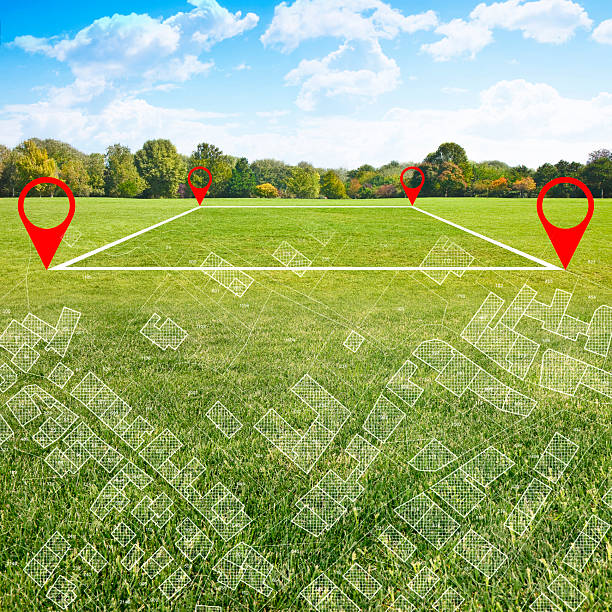 istock Land plot management - real estate concept with a vacant land on a green field available for building construction and housing subdivision in a residential area with an imaginary cadastral map on background 2219346268
