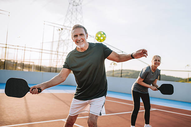 istock Mature, elderly couple play pickleball together 2219346834