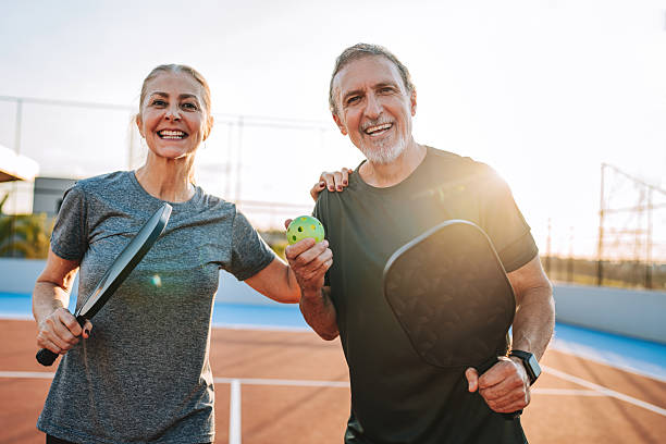 istock Mature, elderly couple play pickleball together 2219346976