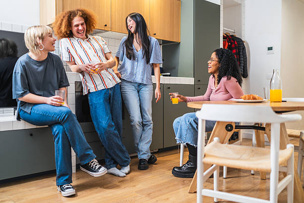 istock Young multiethnic friends enjoying breakfast and conversation in modern kitchen 2219346998