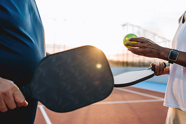 istock Pickleball detail holding racket and ball 2219347033