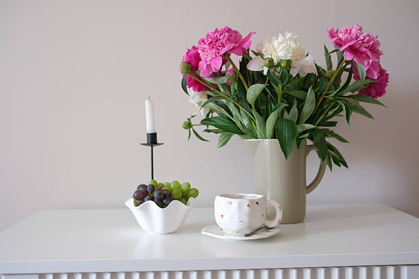 istock Beautiful and Elegant Floral Arrangement Featuring a Charming Teacup and Fresh Fruit on Table 2219347123