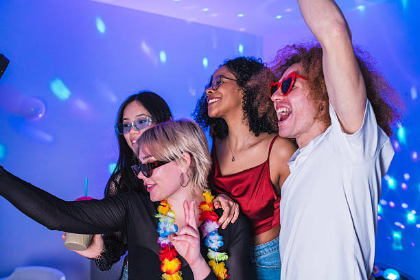 istock Young people taking selfie at house party with disco lights 2219347363