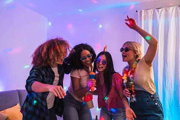 istock Young multiethnic friends singing karaoke at home party 2219347802