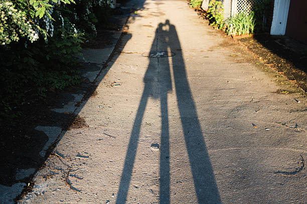 two people, shadow, kissing,  alley