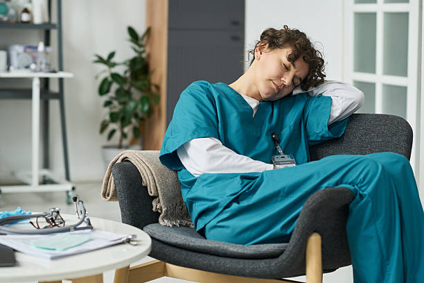 istock Exhausted Medical Professional Resting in Break Room 2219357233