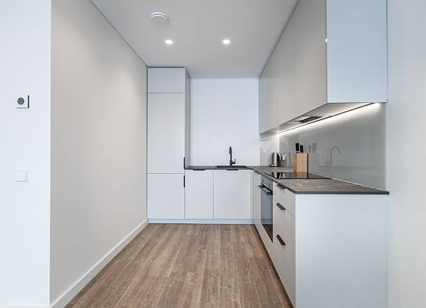 istock Modern Kitchen with Minimalist White Cabinets and Black Details 2219358571