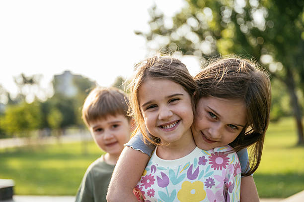 istock Cute kids playing in the aprk on sunny day 2219358729