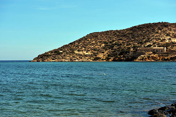 beach in Mazarrón, Spain, with red rocks the beach is characterized by fine golden sand and crystal clear water, town located in the region of Murcia, in the south-east of Spain