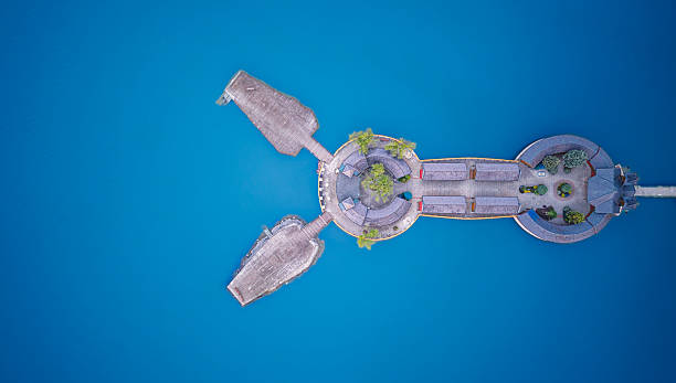 istock Panoramic view of an island with stone structures surrounded by clear blue water 2219362372