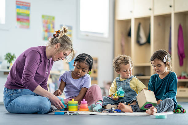 istock Group of Children Learning with Teacher in a Preschool Environment 2219363024