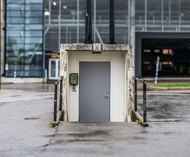 istock Small utility door surrounded by cityscape rain scene.. 2219363108