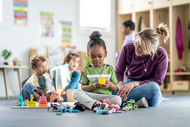 istock Teacher Engaging with Children During Learning Activities in a Bright Classroom 2219363462