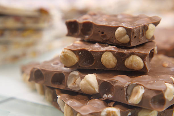 A tempting stack of chocolate nougat with whole hazelnuts.