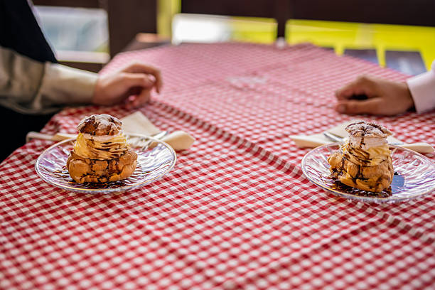 A plate of cream-filled profiteroles elegantly served on the terrace table