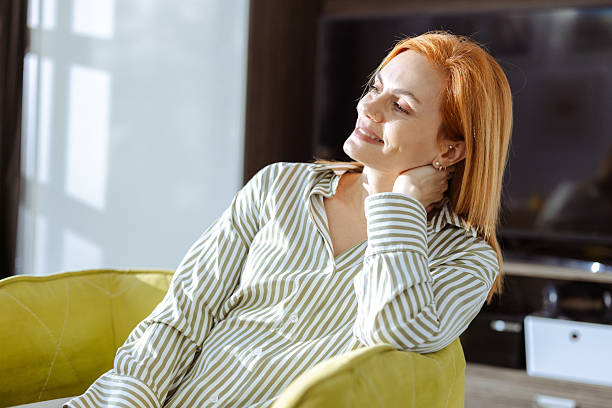 istock Relaxed woman enjoying sunlight in cozy modern home environment 2219366461