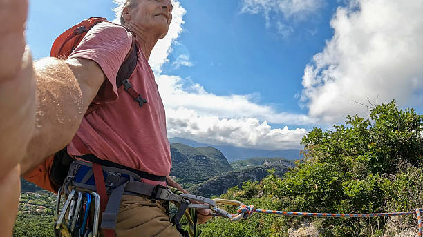 istock Profile view of climber on mountain top 2219366541