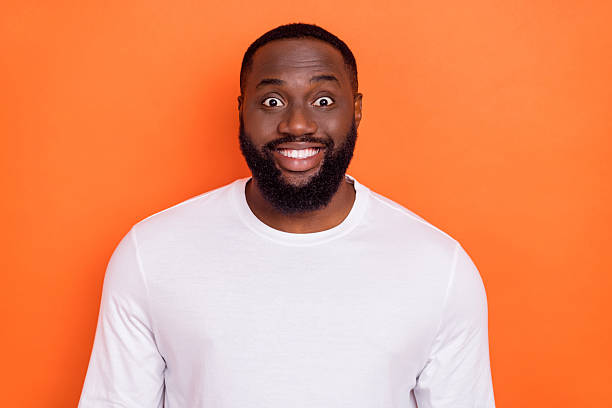 istock Photo of attractive funny guy dressed white pullover smiling isolated orange color background 2219366594