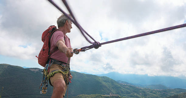 istock View down safety rope to climber on mountain top 2219366773