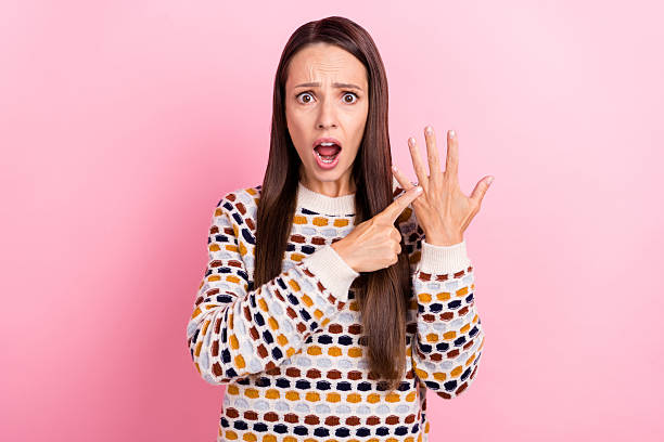 istock Photo of shocked sad mature lady dressed print pullover pointing finger asking where her proposal ring isolated pink color background 2219369002