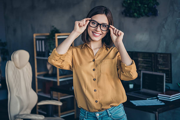 istock Portrait of attractive intelligent cheerful girl expert touching specs developing web project at workplace workstation indoors 2219369760