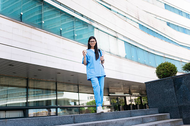istock Young medical professional walking outside modern building 2219371643
