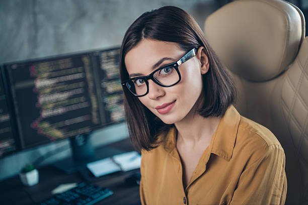 istock Portrait of attractive intellectual girl web developer service network tech support improving at workplace workstation indoors 2219373123
