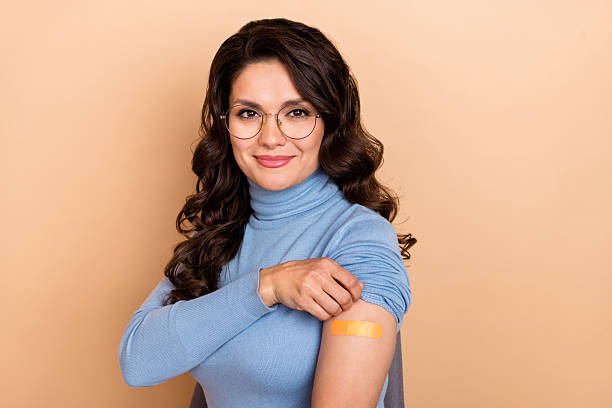 istock Photo of shiny charming lady dressed blue pullover glasses showing sticky plaster isolated beige color background 2219375511
