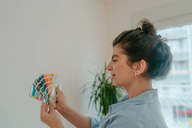 istock Choosing a wall paint from a color swatch 2219376605