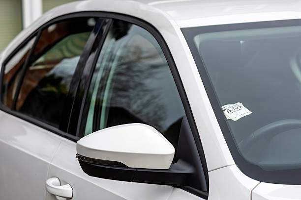 istock A pay-and-display parking ticket is displayed on the dashboard of a modern white car. The image represents city parking, transportation costs, following rules, and urban life 2219378363