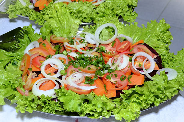 istock Plate with lettuce salad with tomatoes, sliced ​​onions, beetroot, carrots and chives 2219379913