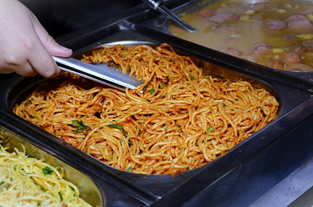A tray of pasta with tomato sauce for a party