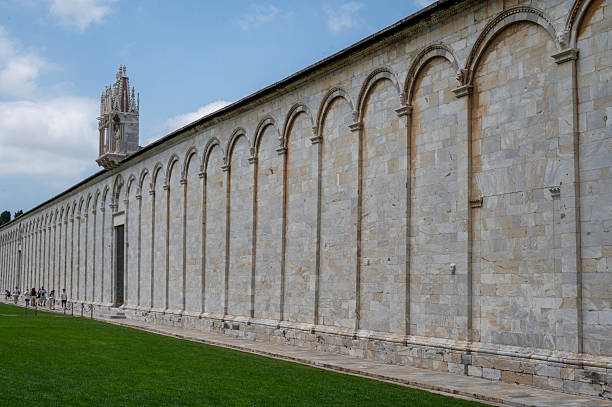 Pisa, Tuscany, Italy - June 07, 3025: The Camposanto Monumentale of Pisa is a historic cemetery located in the Piazza dei Miracoli, an elegant cemetery for famous Pisans enclosed in a rectangular cloister with restored 14th-century frescoes.