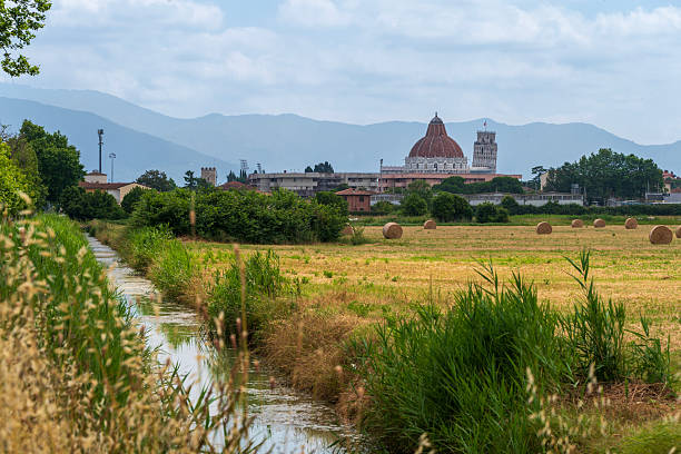View on Arno river and colorful building, reflection in water, Pisa, Tuscany, Italy