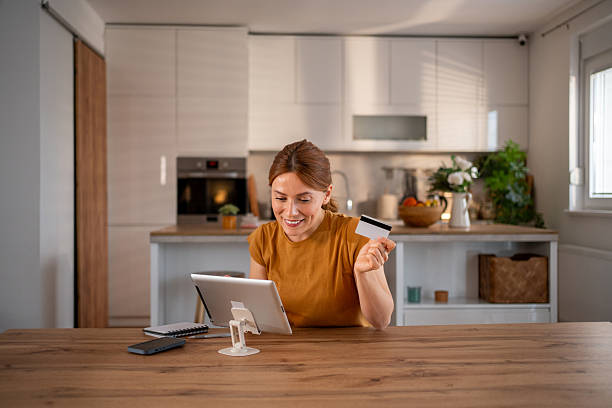 istock Woman making online payment using digital tablet and credit card at home 2219389172