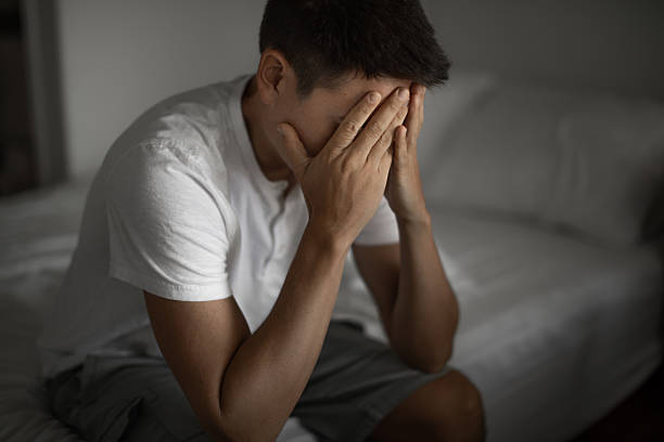 istock Sad lonely man sitting in the bedroom. 2219389482